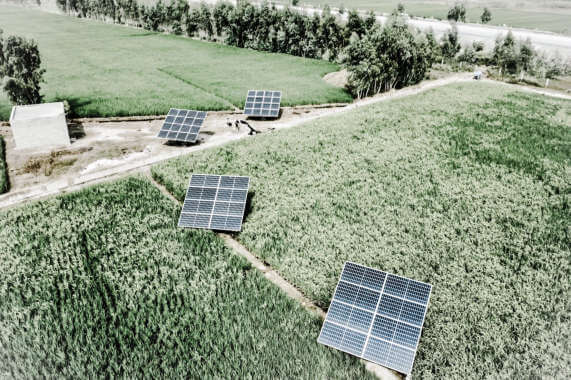 Vedere aeriana a panourilor solare amplasate pe un camp, cu monitorizare wireless pentru eficienta maxima.